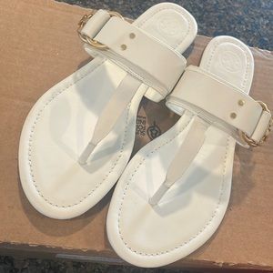 White women’s Tory Burch sandals.